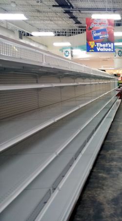 Empty shelves at a grocery store by Flickr user Chris Waits